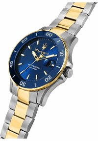 Herrenarmbanduhr mit blauem Zifferblatt, goldenen Akzenten und Armband aus rostfreiem Stahl. Verfügt über eine Lünette, große Indizes und eine Wasserbeständigkeit von bis zu 100 m.