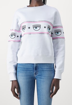 Felpa bianca con stampe grafiche di occhi e stelle, accentuata da strisce rosa e argento. Realizzata in tessuto morbido, con polsini a coste.