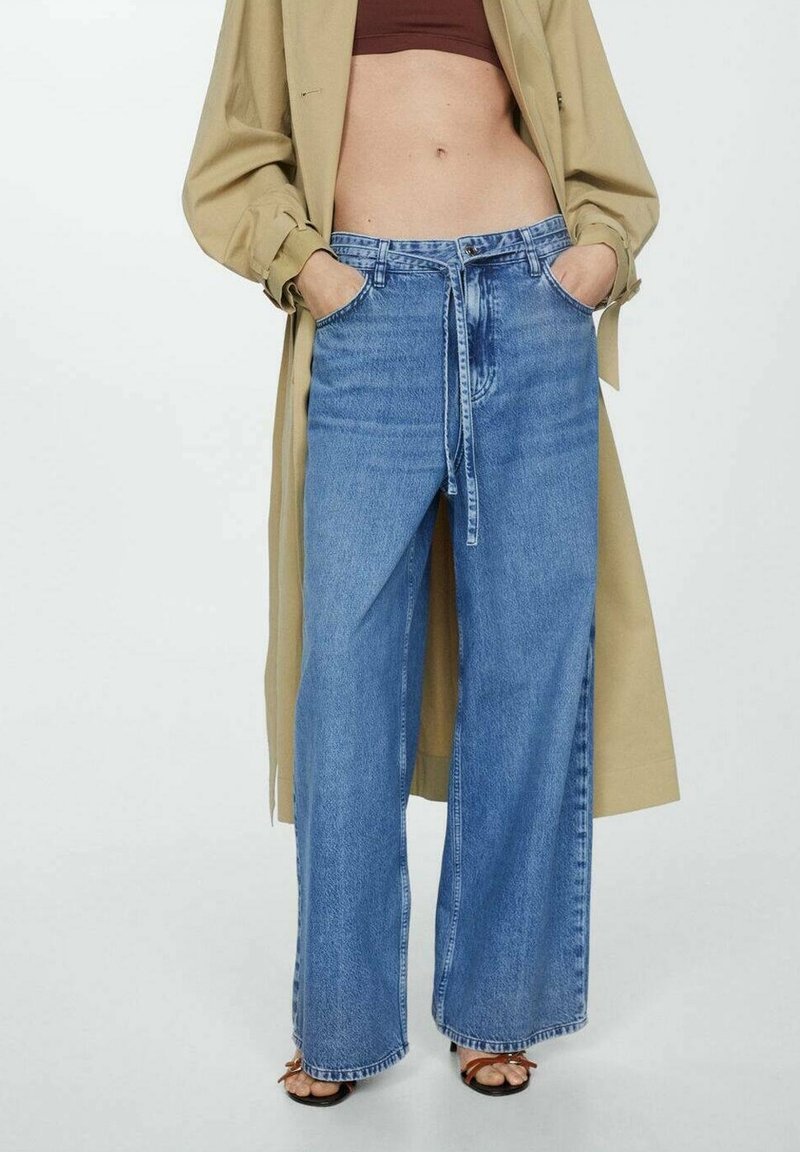 Jeans in denim blu a gamba larga con una vestibilità rilassata, dotati di chiusura a bottone e cravatta, due tasche anteriori e una finitura sbiadita.