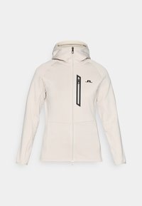 Lichtbeige zip-up jack met een capuchon en zwarte accenten. Beschikt over een voorzak met rits en een gladde, licht gestructureerde stof.