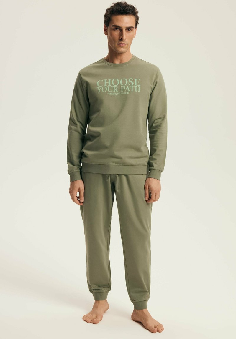 Olive green sweatshirt with "CHOOSE YOUR PATH" text, paired with matching jogger pants. Both made of soft, smooth fabric with ribbed cuffs.