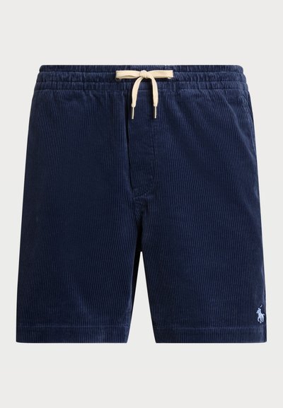 Calções de veludo cotelê azul-marinho com uma cintura elástica e um cordão de cor creme. Apresenta um pequeno logotipo branco na bainha inferior.