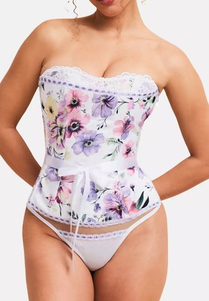 Corset floral sans bretelles en satin blanc avec des fleurs violettes et roses. Il dispose d'une garniture en dentelle, d'une forme peplum et d'un lien à la taille en ruban.