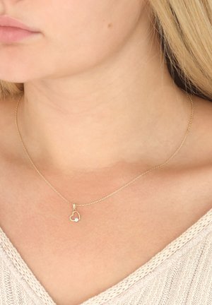 Gold chain necklace featuring a heart-shaped pendant with a small gemstone accent. Simple design and smooth texture.