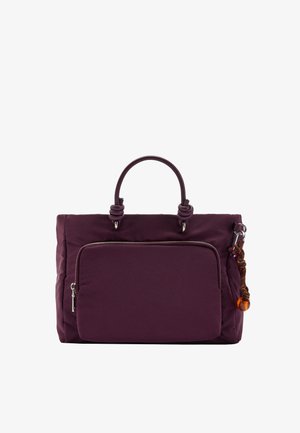 Ciemnofioletowa torebka z przednią kieszenią na zamek, okrągłymi uchwytami oraz dekoracyjnym brązowo-pomarańczowym sznurkiem przymocowanym do bocznego pierścienia.