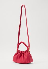 Red leather handbag with a gathered design, twisted top handle, adjustable shoulder strap, and gold hardware accents.