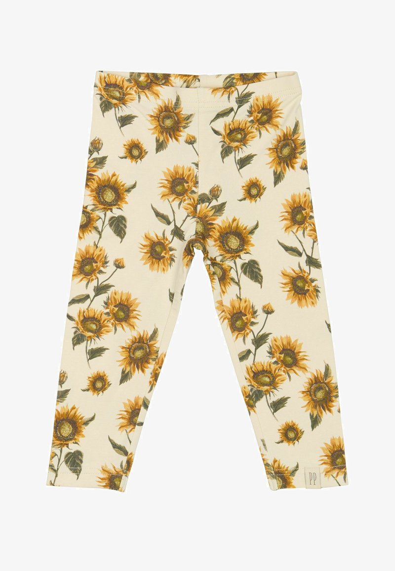Leggings v svetlo bež barvi s potiskom sončnic, ki vsebujejo sončnice v rumeni in zeleni barvi. Narejene iz mehkega, raztegljivega materiala za udobje.