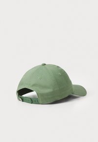 Green fabric cap with a curved bill, adjustable strap, and embroidered detail on the back. Smooth texture and structured design.