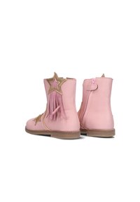 Pink leather ankle boots featuring gold star accents and fringes, with a side zipper and a textured brown sole.