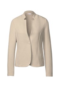 Beige blazer van een gestructureerde stof, met een open voorkant en een enkele knoopsluiting. Heeft een moderne kraagloze ontwerp en lange mouwen.