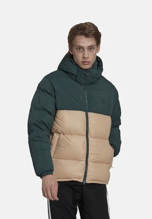 Pufferjakke med en mørkegrøn top og beige bund, udstyret med hætte, lynlås lukning og elastiske cuffs for varme. Tekstureret stof med synlige sømme.