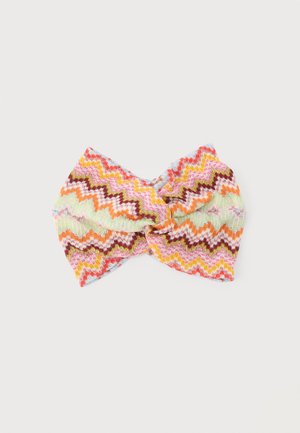 Colorful knitted headband with twisted knot design and zigzag pattern in pink, orange, yellow, brown, and light green tones.