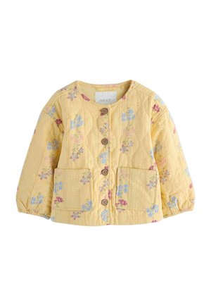Yellow quilted jacket with floral pattern, front button closure, two pockets, and elasticized sleeves. Crafted in lightweight fabric.