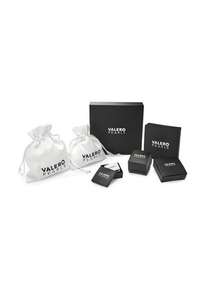 Two white satin pouches and several black boxes, all featuring "VALERO PEARLS" branding, displayed on a white background.