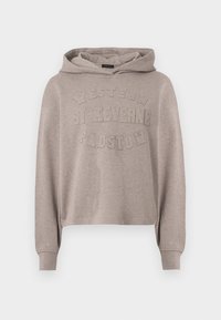 Bež kapucar z dolgimi rokavi in izbočenim besedilom »Western St Keverne Padstow« na sprednji strani.