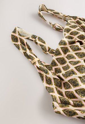 Top in tessuto stampato con sfondo beige e motivi di foglie in blu scuro e oro. Spalline regolabili con dettagli in oro.