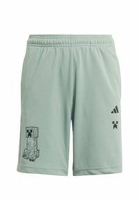 Svetlozelené športové šortky s elastickým pásom, na ľavom stehne s čiernym grafickým motívom Creeper a s logom Adidas na pravom stehne.