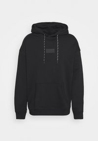 Black hooded sweatshirt with a front pocket, ribbed cuffs, and drawstrings. Features a textured brand patch on the chest. Soft fabric.