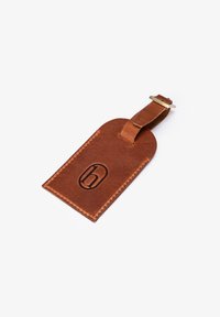 Brown leather luggage tag with rounded top, a loop strap, embossed logo, and contrasting stitching detail along the edges.