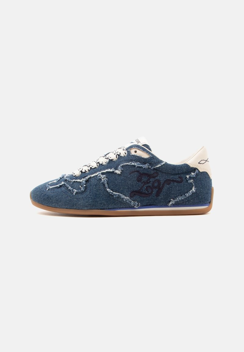 Casual αθλητικό παπούτσι με μπλε denim ύφασμα, λευκά κορδόνια, φθαρμένες και σκισμένες λεπτομέρειες και σόλα από καουτσούκ, εμφανίζεται σε απλό φωτεινό φόντο.