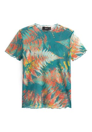 Blouse turquoise à manches courtes avec motif de feuilles de fougère orange et blanche, tissu transparent, et bords festonnés sur les manches et l'ourlet.