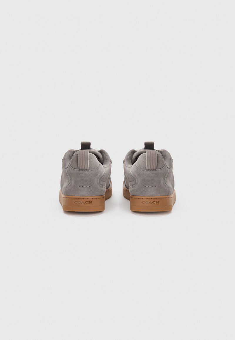 Gray suede sneakers with a tan rubber sole. Features a pull tab at the heel and textured accents on the collar.