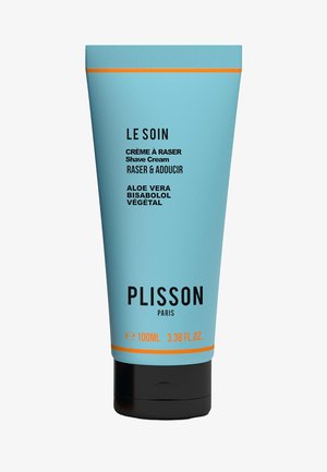 Helle blaue Tube mit Plisson Rasiercreme, 100 ml. Hat schwarzen Text und einen orangefarbenen Akzentband. Die Inhaltsstoffe umfassen Aloe Vera und Bisabolol.
