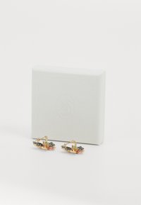 Gold-tone earrings with floral design, featuring green, pink, and gray accents. Packaged in a textured white box.