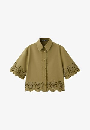 Olive green short-sleeve shirt with pointed collar, button front, and scalloped lace cutout detailing on sleeves and hem.