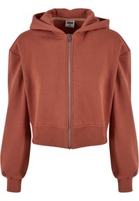 Rustfarget, cropped hettegenser med glidelås foran, storhette og ribbestrikkede mansjetter. Laget av myk, glatteksturert stoff, med et avslappet, boksaktig design.