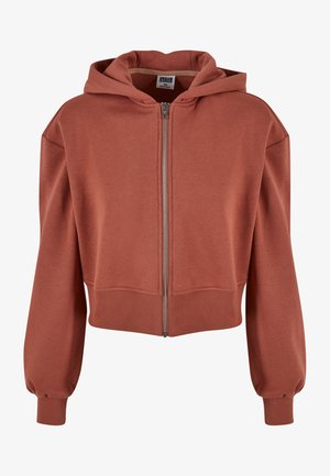 Rust-colored cropped hoodie with a zip front, large hood, and ribbed cuffs. Made of soft, smooth fabric, featuring a relaxed, boxy design.