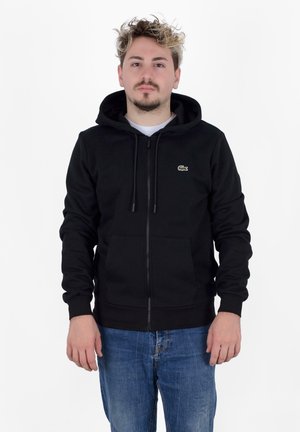 Felpa nera con zip realizzata in misto cotone, con tasca a marsupio, cappuccio con stringhe e piccolo logo ricamato sul lato sinistro del petto.