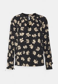 Blusa nera con motivi floreali crema, maniche lunghe, scollo rotondo e un orlo leggermente asimmetrico. Tessuto morbido con vestibilità comoda.
