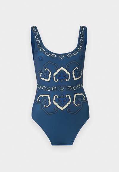 Blue one-piece swimsuit with wide straps and symmetrical white and dark blue ornamental patterns across front and neckline.