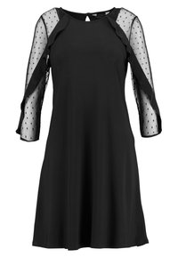 Svart klänning med trekvarts genomskinliga prickiga ärmar, rund halsringning och utställd kjol. Mjukt tyg med en slät textur. Detalj med nyckelhål i ryggen.