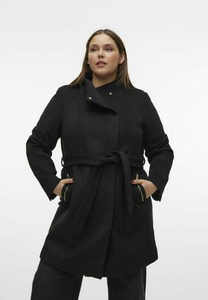 Manteau noir en laine avec une taille ceinturée, un col montant et des accents en doré sur les poches. Texture lisse, design mi-long, à boutonnage simple.