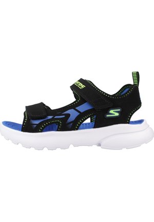 Infradito neri e blu con cinturini regolabili, suola bianca e dettagli verdi. Presentano un design traspirante con un battistrada strutturato.