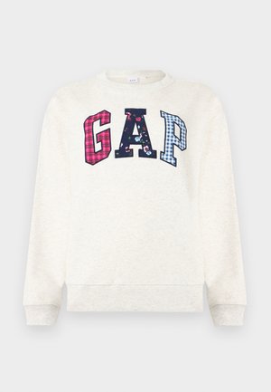 Ekrü hosszú ujjú melegítőfelső nagy "GAP" betűkkel, piros kockás, tengerészkék virágos és kék kockás mintákkal a mellrészen.