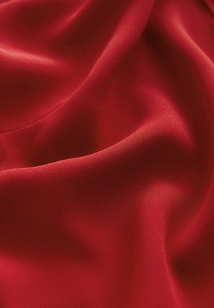 Red fabric with a smooth texture, featuring subtle sheen and creased drapes, showcasing a lightweight and flexible design.