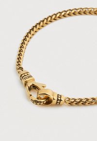 Κολιέ με αλυσίδα σε χρυσό τόνο με σπειροειδές σχέδιο, διακοσμητικό κούμπωμα και μικρές χάντρες κατά μήκος των συνδέσμων.