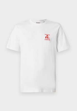 T-shirt in cotone bianco con stampa grafica rossa sul petto sinistro, che raffigura un pugile con la scritta "SHANGHAI CHAMPION." Maniche corte.