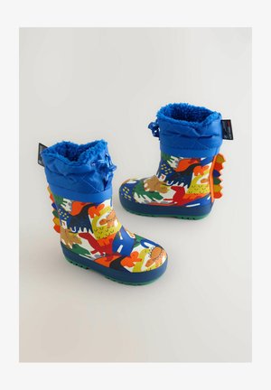 Farverige gummistøvler med et livligt dinosaurmønster, blå kviltet kant, grøn sål og orange detaljer på hælen.