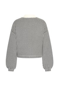 Cropad svartvit mönstrad tröja med långa puffärmar och en vit krage. Materialet verkar ha en textur med ett rutigt mönster.