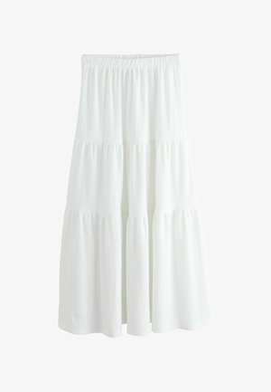 Jupe blanche à volants avec une ceinture élastique, faite d'un tissu texturé. Elle possède trois couches distinctes pour une silhouette fluide.