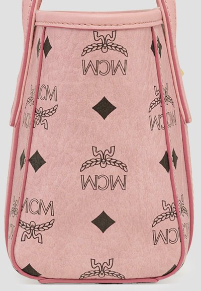Pink leather handbag featuring a geometric pattern with black MCM logos and diamond shapes. Structured design with trimmed edges.