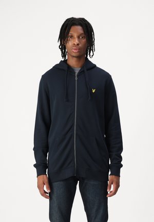 Navy blue zip-up hoodie made of soft fabric, featuring a kangaroo pocket, drawstring hood, and a small yellow logo on the chest.