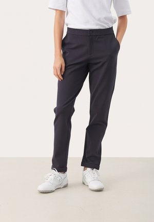 Navy trousers with a smooth texture, slim fit, and straight legs. Features a button closure, belt loops, and side pockets. Worn with white sneakers.