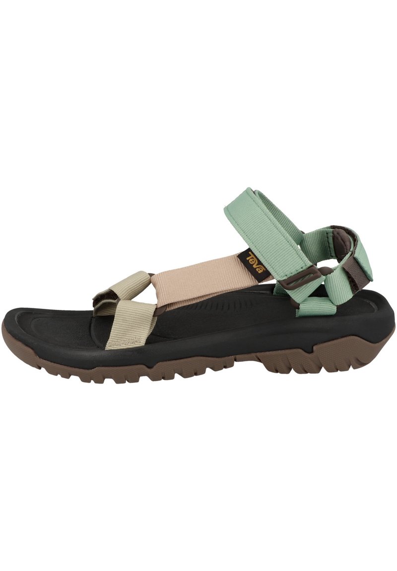 Adjustable multi-strap sandals featuring green, beige, and black materials. Textured rubber sole with traction pattern. Lightweight design.