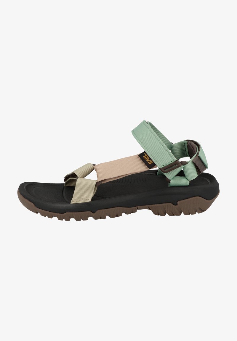 Adjustable multi-strap sandals featuring green, beige, and black materials. Textured rubber sole with traction pattern. Lightweight design.