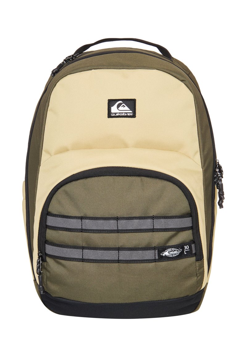 Two-tone beige and olive green Quiksilver backpack with front zip pocket, black base, and logo patches on top and front pocket.